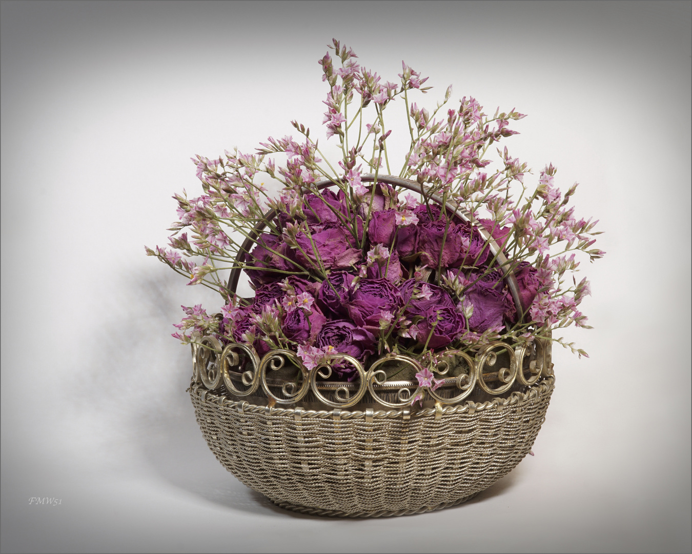 Small floral arrangement in rosé on silverware