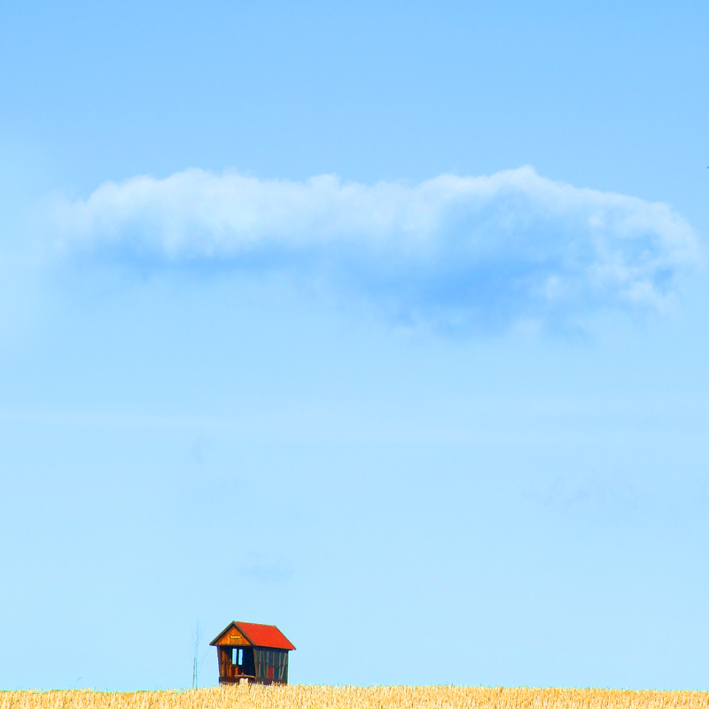 small house under a big cloud