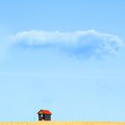 small house under a big cloud