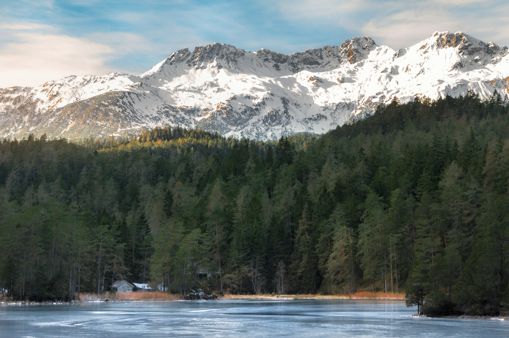 Snow-capped mountains and frozen lake