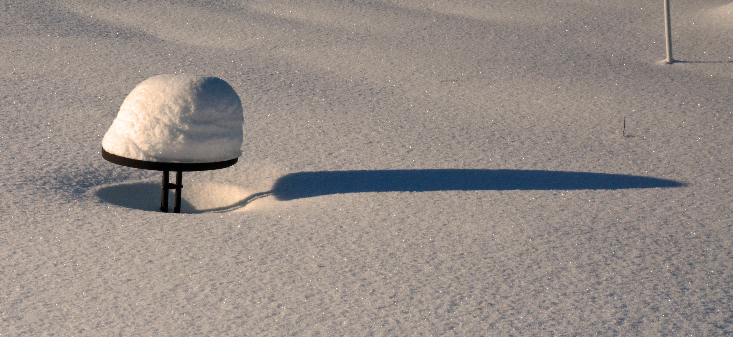 Snowon the table and long shadow