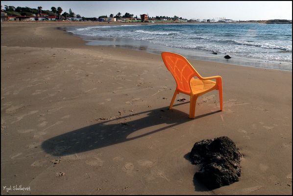 Solitary yellow plastic chair at Israel