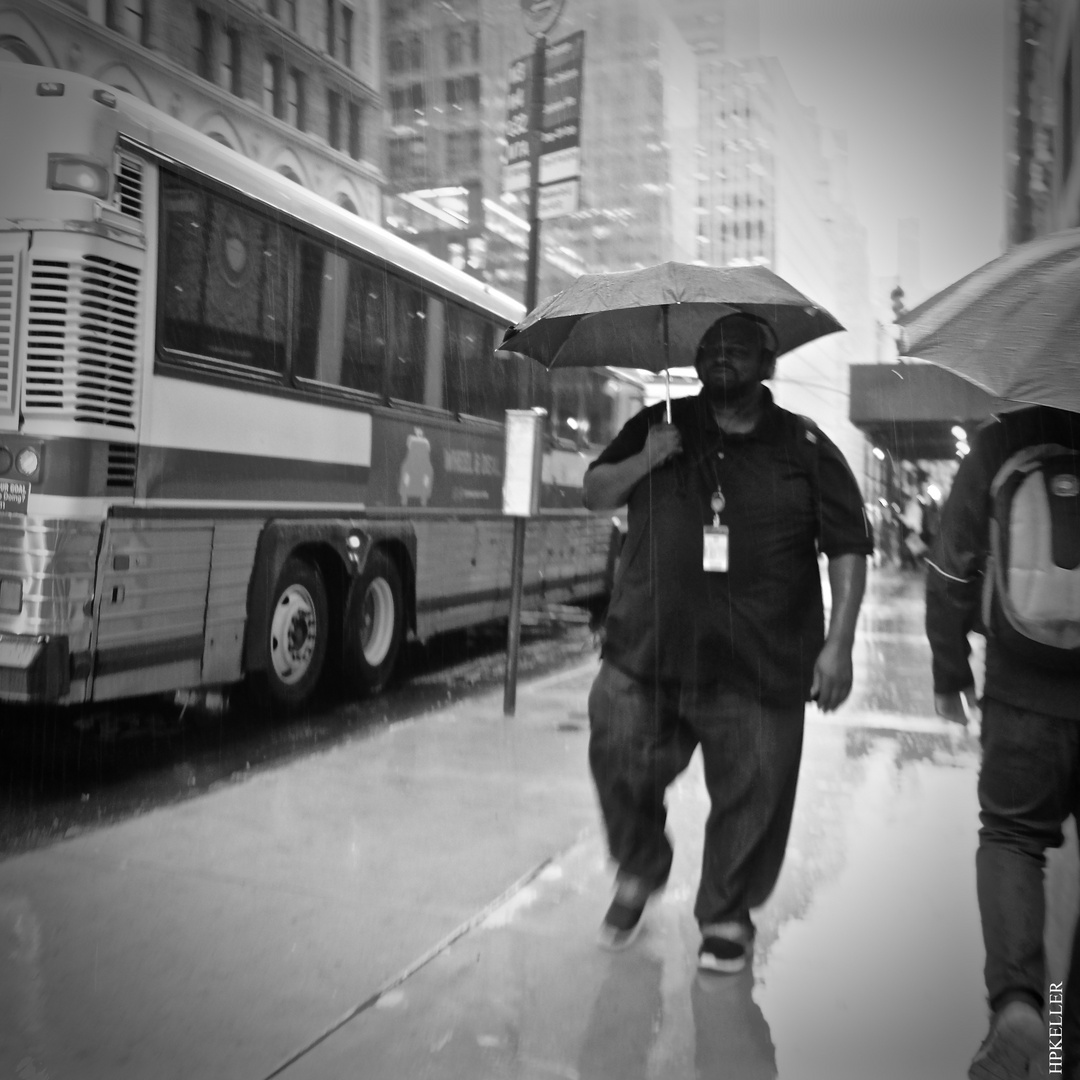 Some weeks ago in Manhattan, ...the umbrella is too narrow for his shoulders.