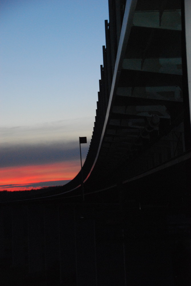 Sonne geht unter einer Bruecke unter