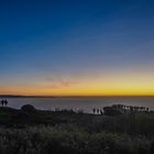 Sonnenuntergang am Strand, der Bodennebel liegt wie ein Schleier über dem Meer