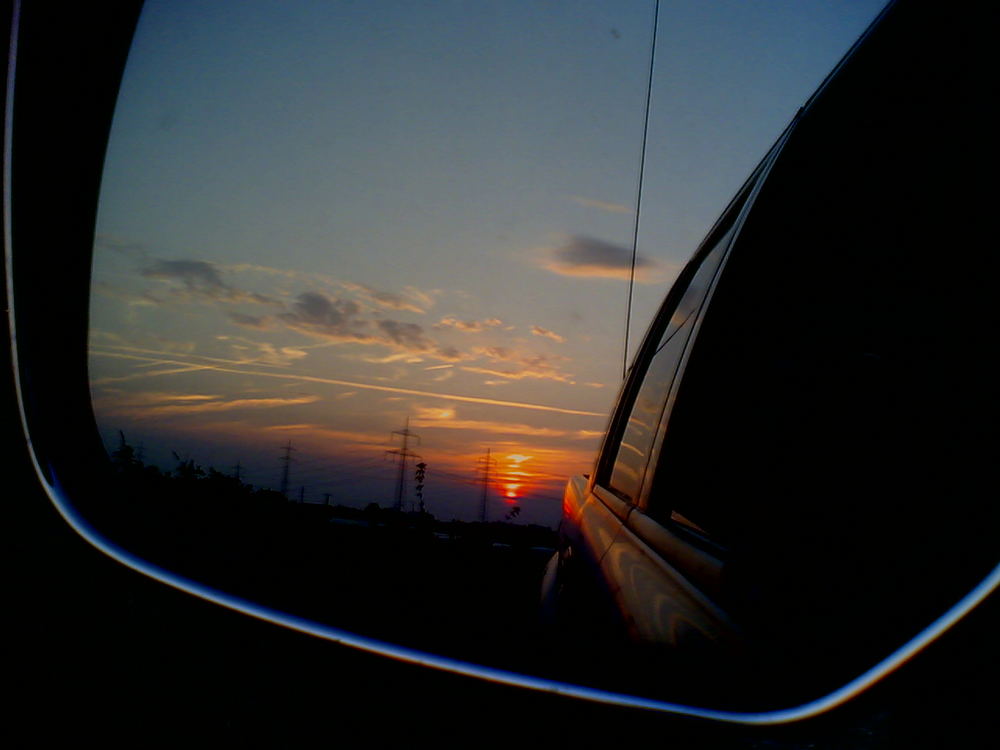 Sonnenuntergang im Rückspiegel meines Pick-up's von Michael U. Anja Werner