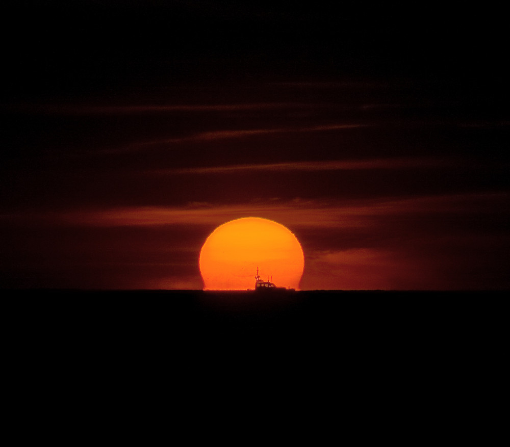 Sonnenuntergang mit Fischerboot