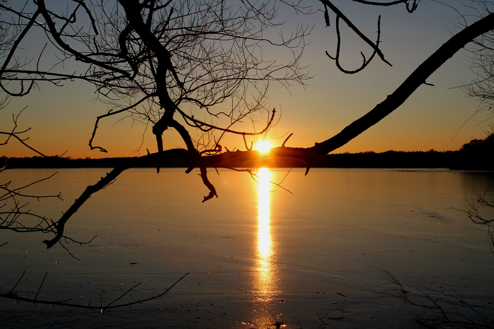 Sonnenuntergang über dem zugefrorenen See