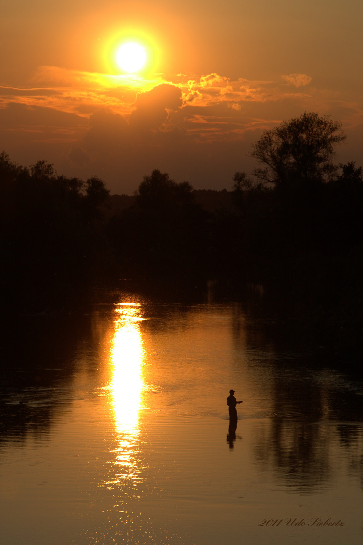 Sonnenuntergang und Angler