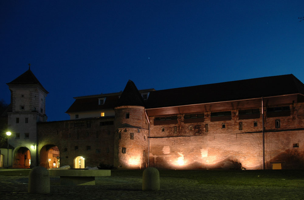 Stadtmauer und Sandauer Tor bei Nacht