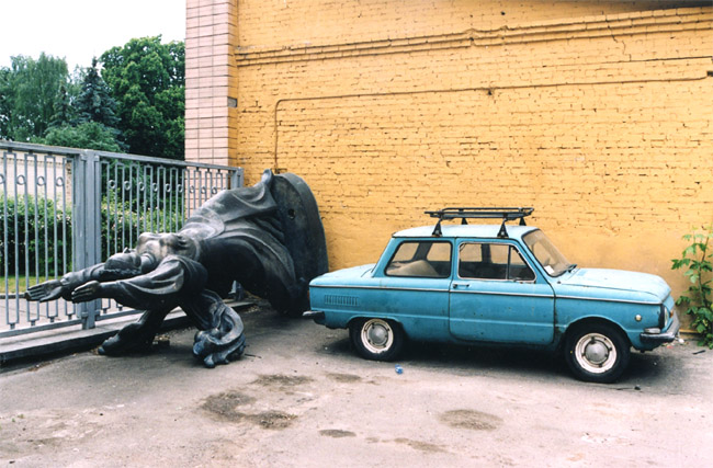 statue with a blue car