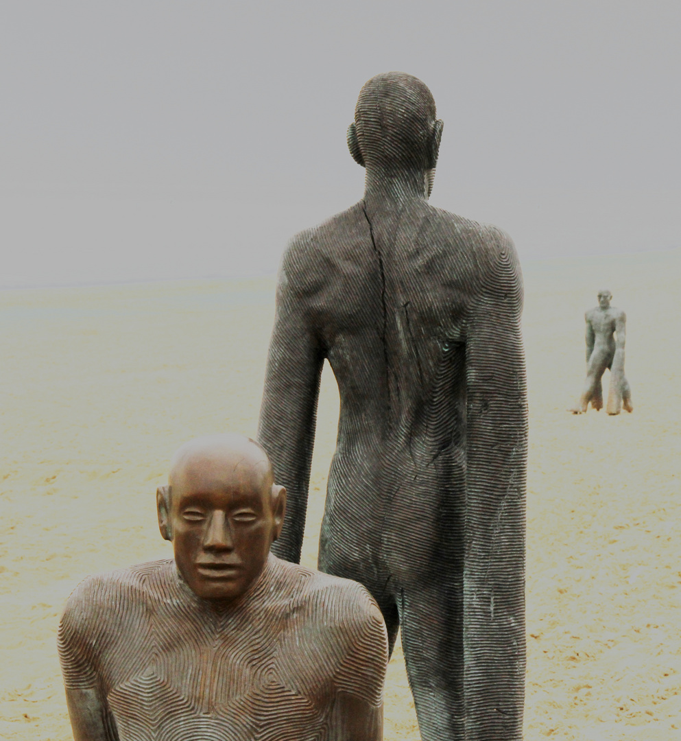 Statues walking on the beach De Panne