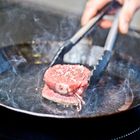 steak in an iron pan