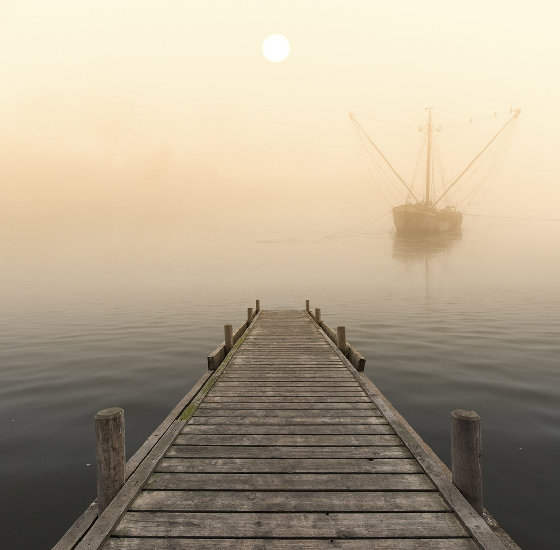 Steg mit Fischerboot im Nebel