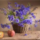 Still-life with a cornflowers basket and peaches