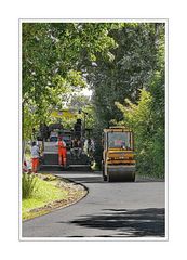 streamroller baby helping smoothe out a new road surface (he is rolling past our driveway)