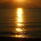 sun having a bath in the sea under the Athos mountain