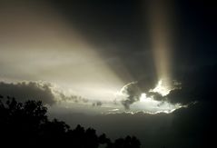 Sun rays from behind the dark clouds