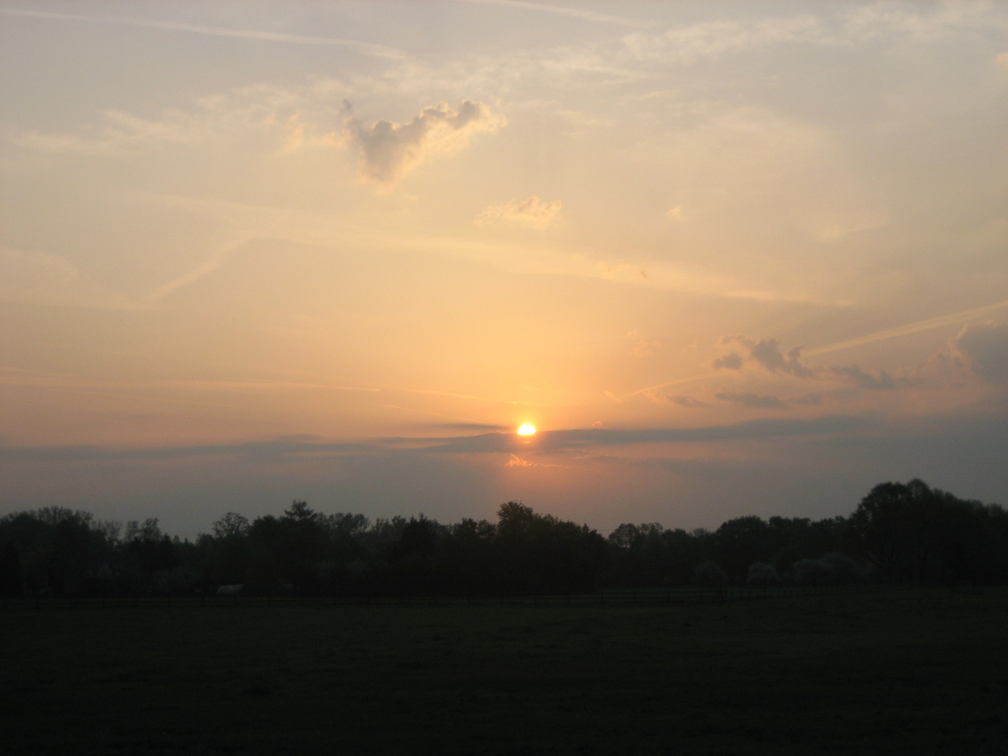 SUN RISE WITH CLOUDS AND CONTRAILS