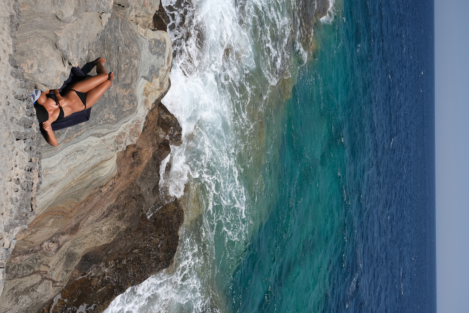 Sunbathing girl on the rocks