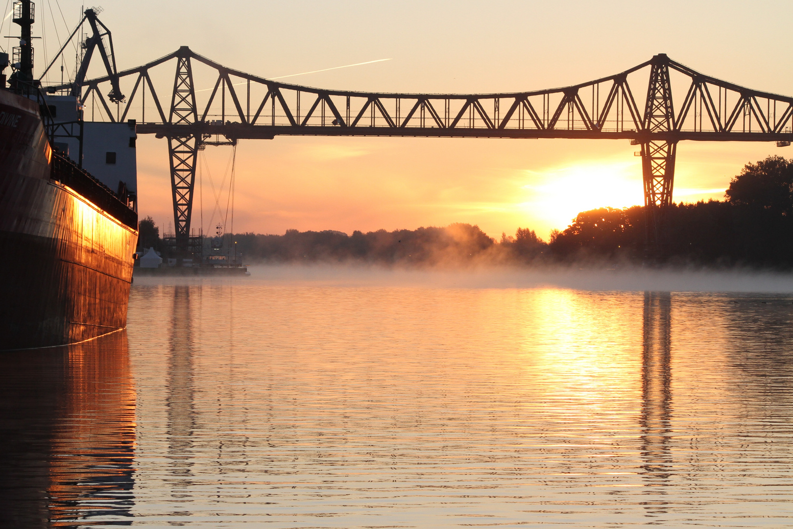 sunrise at Rendsburg - railwaybridge with suspension ferry below  