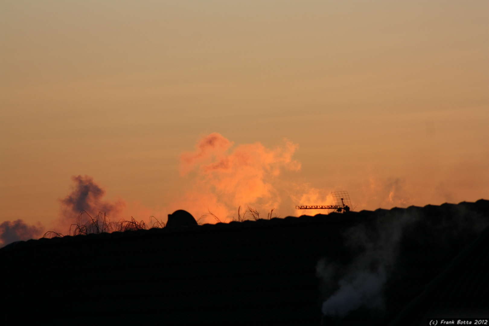 Sunrise behind houses