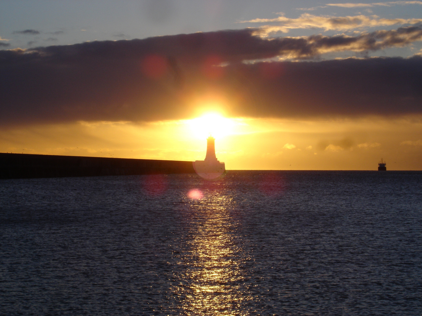 sunrise behind lighthouse in Newcastle upon Tyne