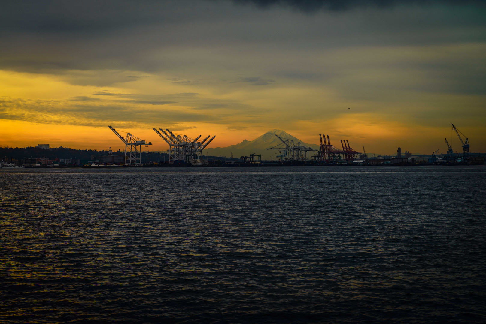 Sunrise behind Seattle and Mount Rainier