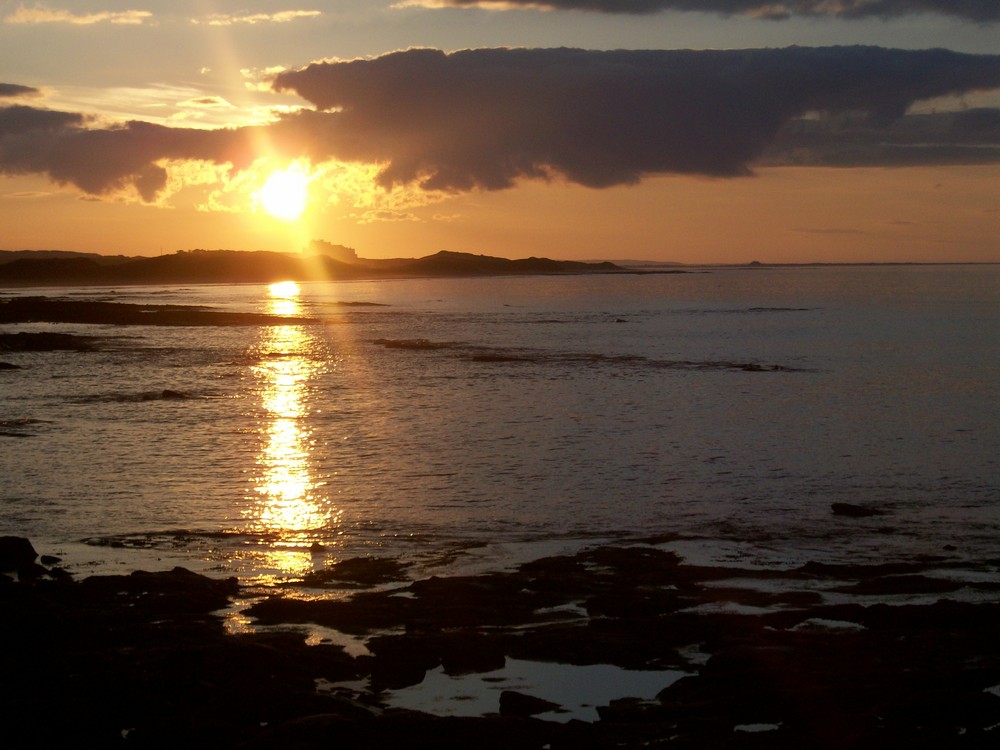 sunset over bamburgh castle