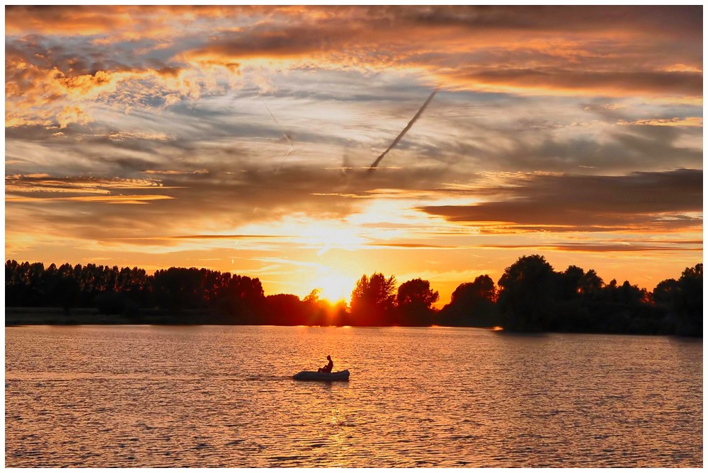 Sunset over the lake of Nieuwkapelle.