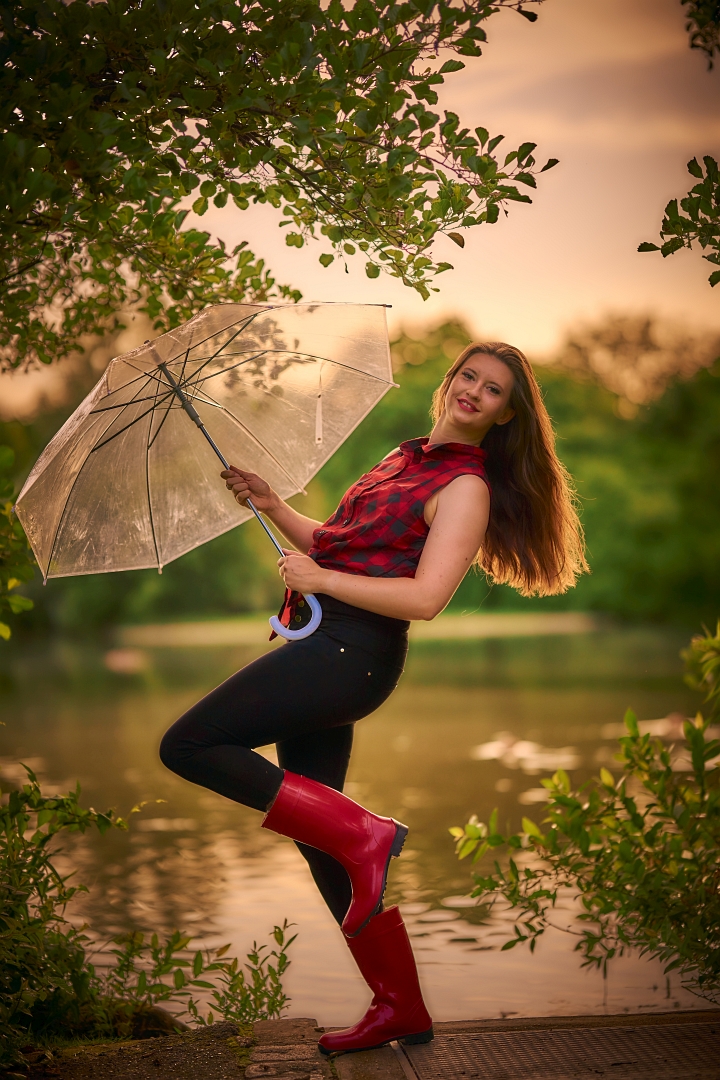 Sunset with rubber boots and umbrella