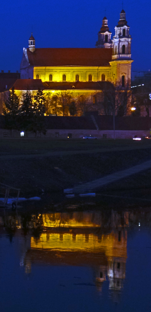 Sv. Rapolo Baznycia, mirrors in River Neris late in the evening, Vilnius, Lithuania