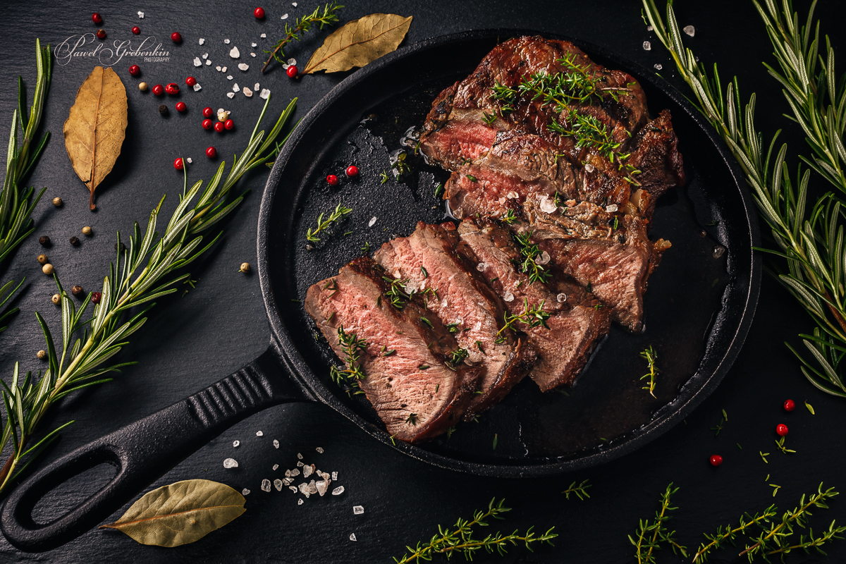 Tender sliced sous-vide beef steak in a cast iron pan