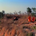 Thai monks visiting the remains of killing machines