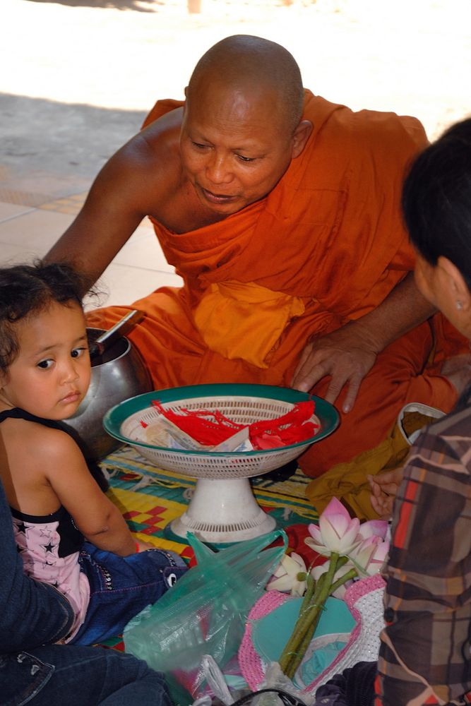 The abbot blesses the child in the temple