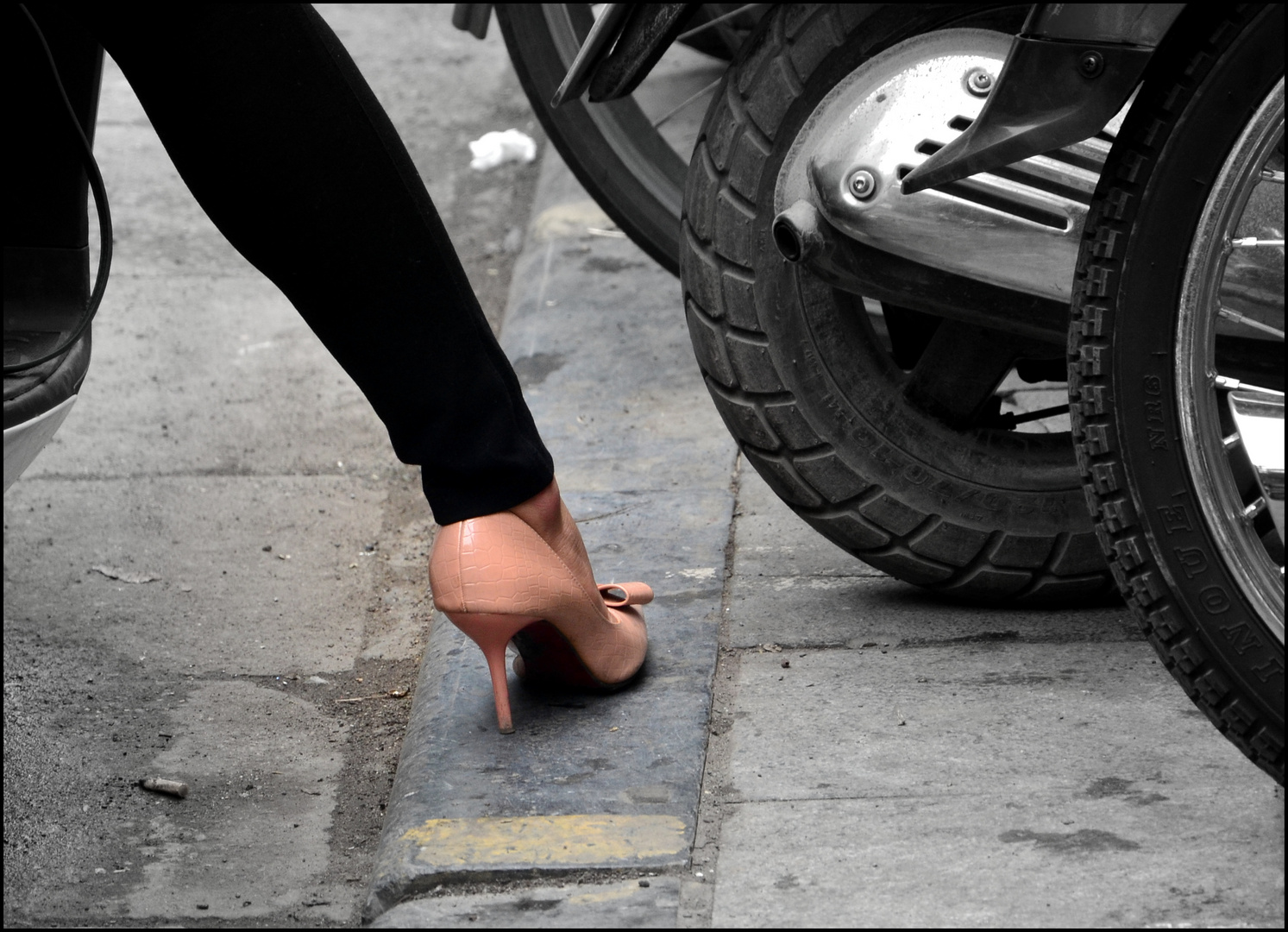 The appropriate shoe to ride a scooter - in the streets of Hanoi.