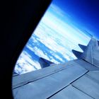 The beautiful sky outside a plane window.