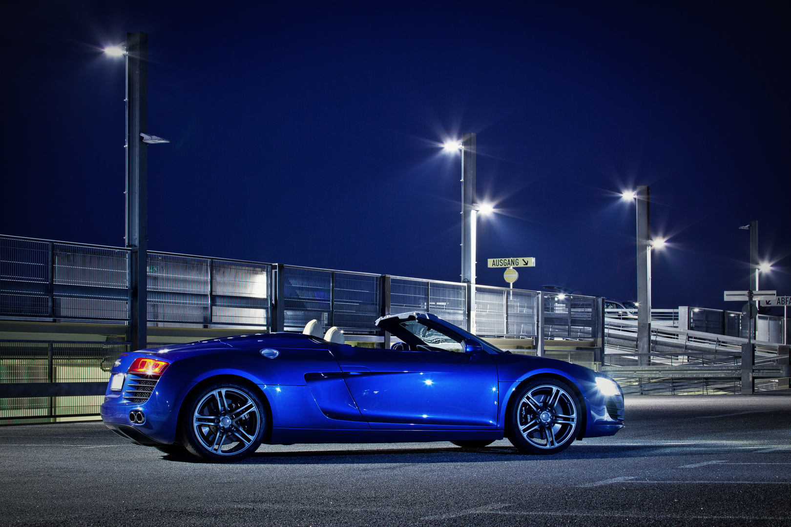 The blue Audi R8 Spyder under the open sky