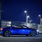 The blue Audi R8 Spyder under the open sky