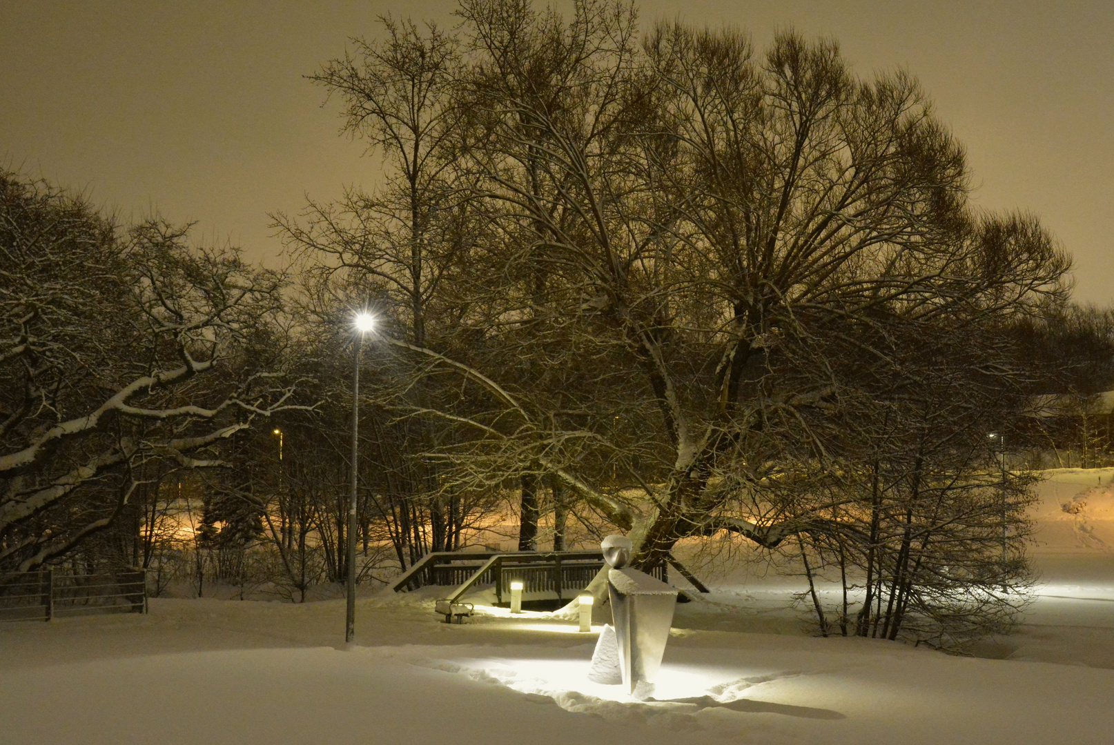 The bridge, bench, tree and statue named "look-out man"