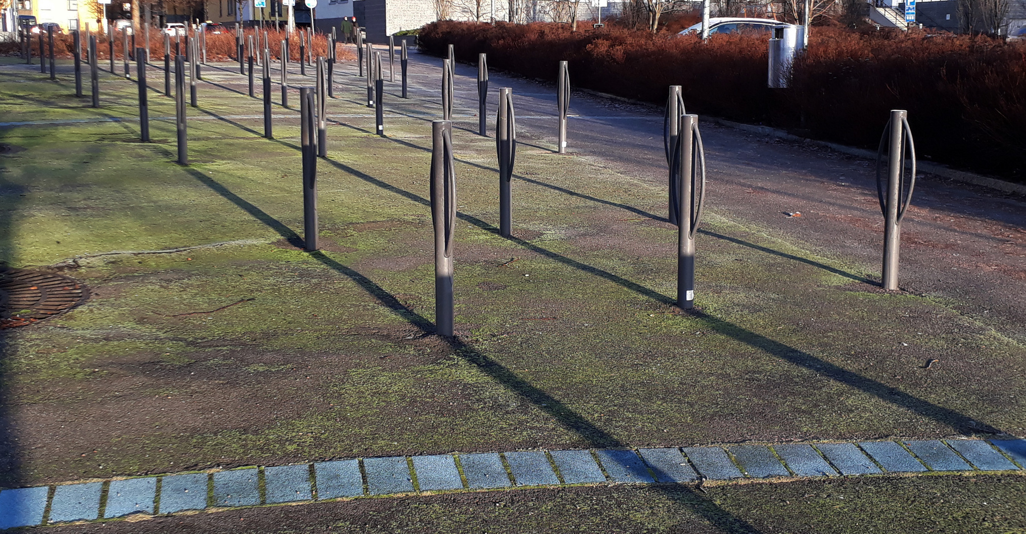 The bysircle parking which the shadows are on the same line with the stand