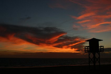 the empty beachguard chair dies at sunset on an empty beach