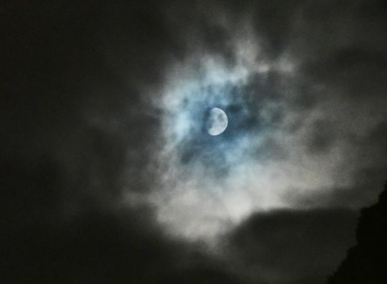The moon behind the clouds
