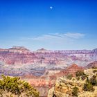 The moon looks over the Grand Canyon