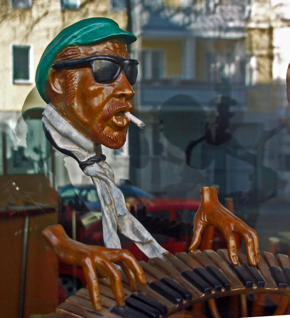 The music maker statue in window