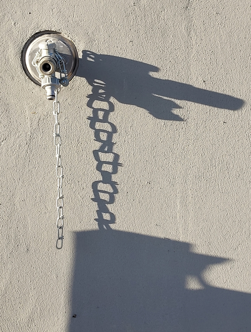 The shadow of water tap and the chain