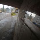 The street view and it reflection on stone wall