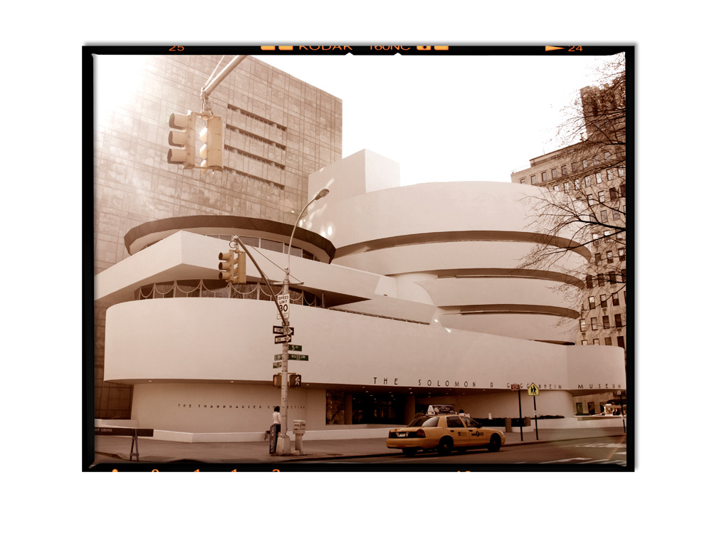 The sun rises behind the Guggenheim