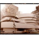 The sun rises behind the Guggenheim