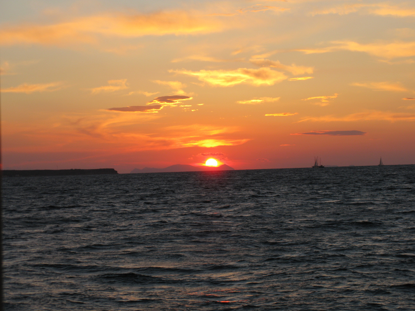 The sunset through the water. The sunlight dyed the surface of water gold.